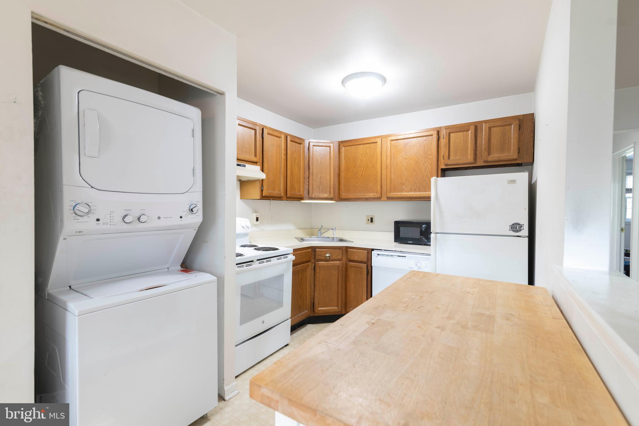 403 South Main Street, Unit C202 Doylestown, PA 18901 - Photo 9 of 18 a kitchen with a refrigerator sink and cabinets