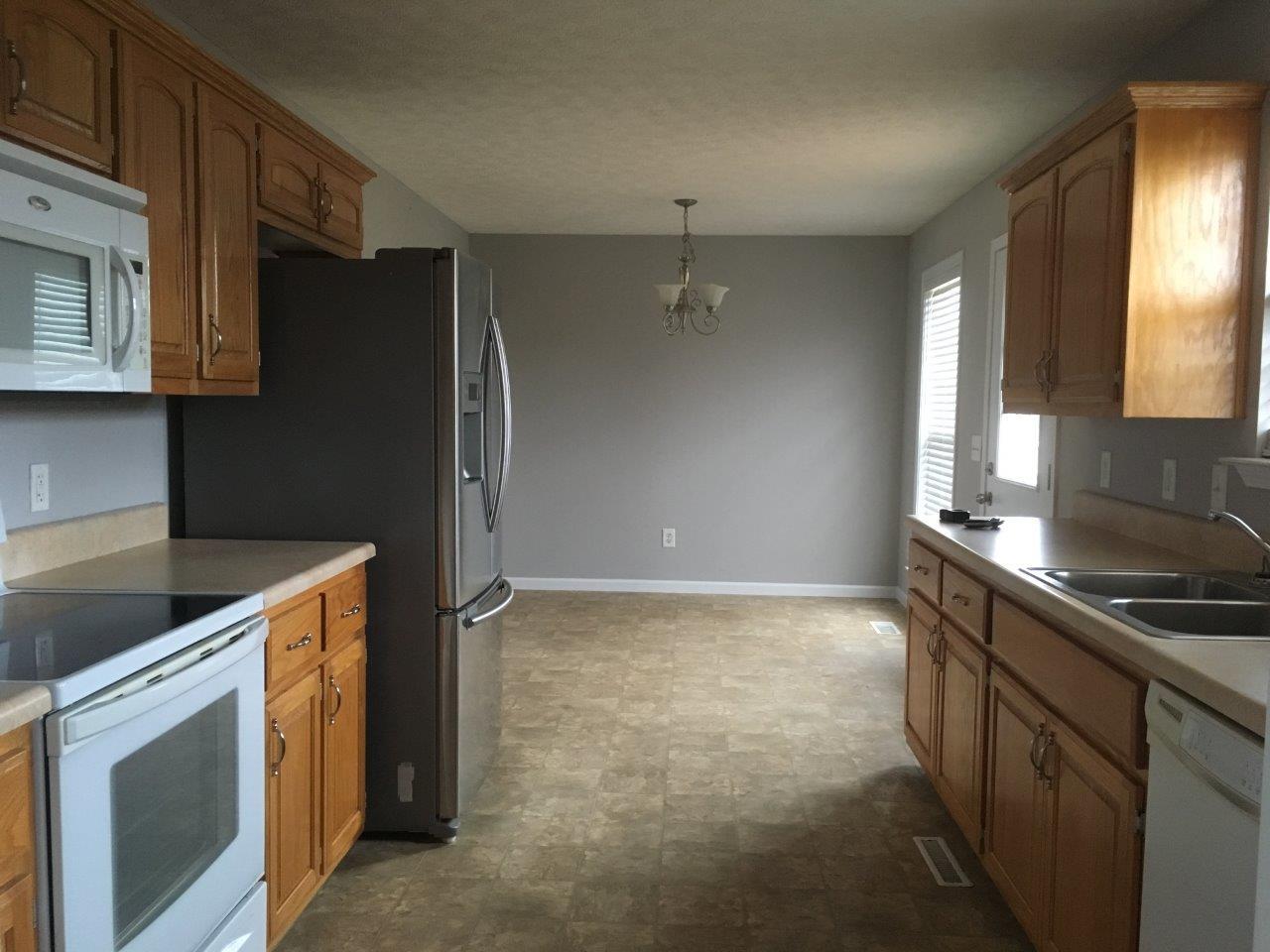1009 Cameron Way Portland, TN 37148 - Photo 13 of 17 a kitchen that has a sink cabinets and a stove top oven