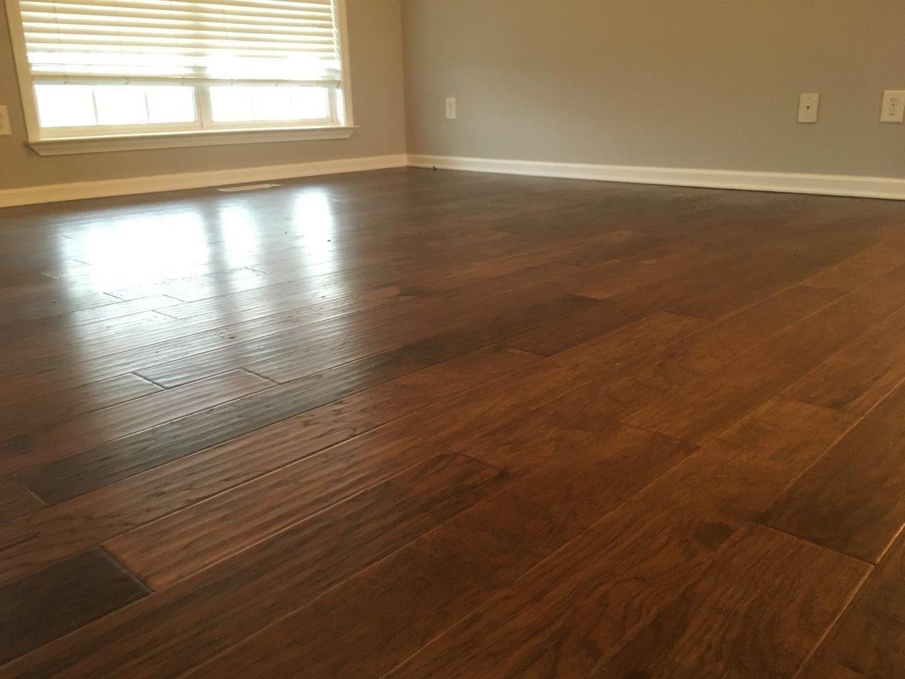 1009 Cameron Way Portland, TN 37148 - Photo 6 of 17 an empty room with wooden floor and windows with curtains