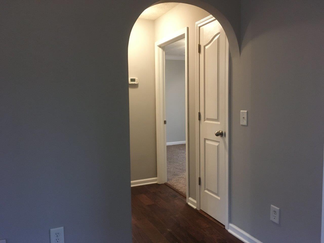 1009 Cameron Way Portland, TN 37148 - Photo 10 of 17 an empty room with wooden floor and mirror