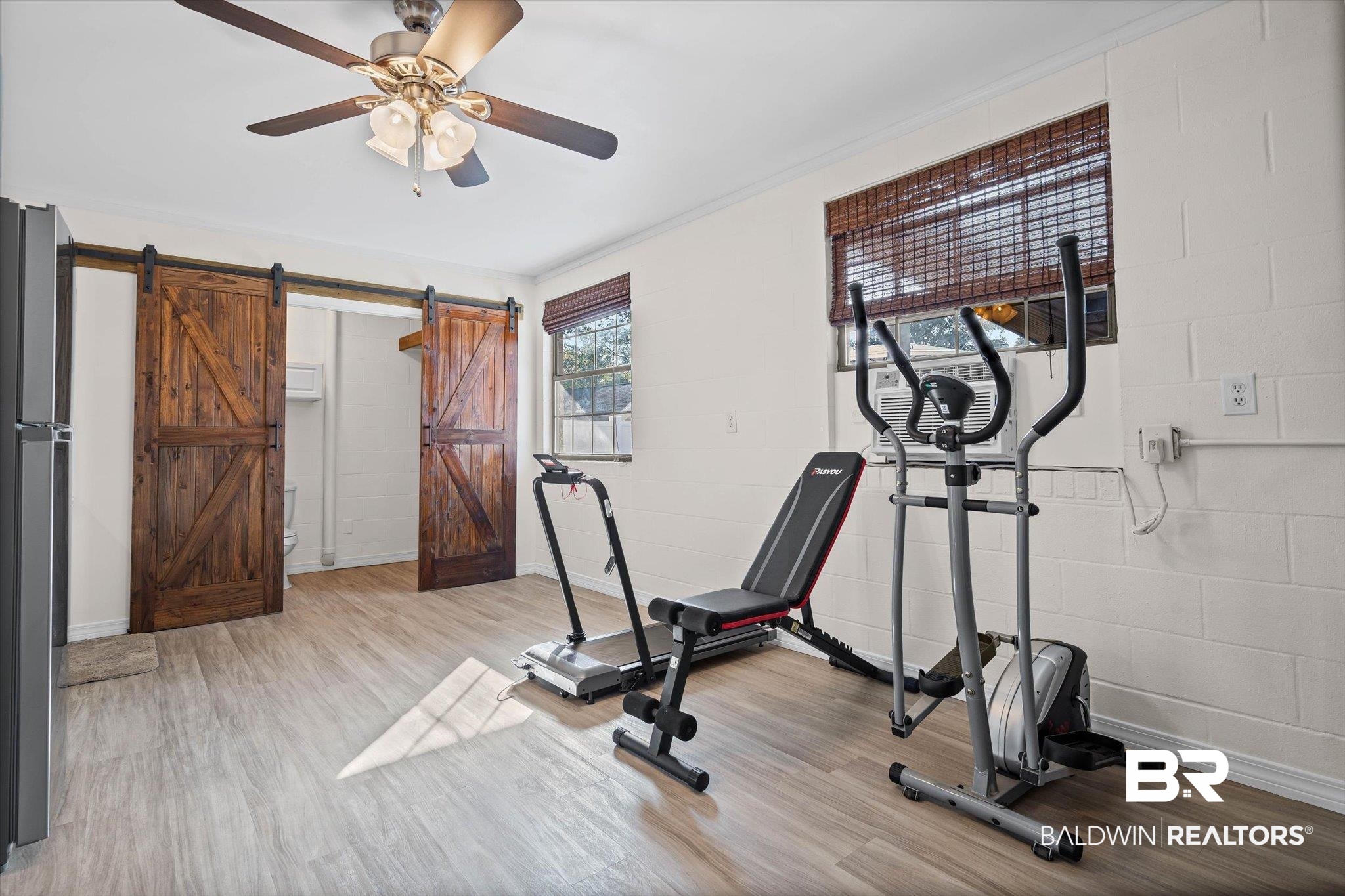 4567 Pine Avenue Saraland, AL 36571 - Photo 35 of 48 Workout room featuring concrete block wall, a ceiling fan, wood finished floors, and ornamental molding