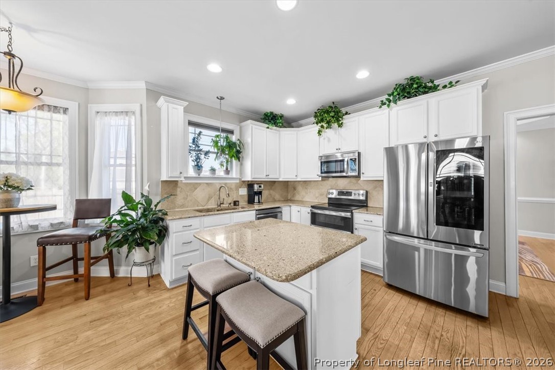 2708 Plum Ridge Road Fayetteville, NC 28306 - Photo 2 of 27 a kitchen with granite countertop a refrigerator and a stove top oven