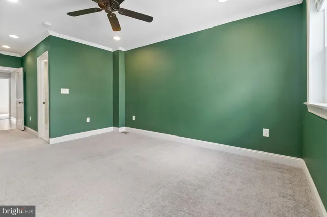 a view of a livingroom with a ceiling fan and window
