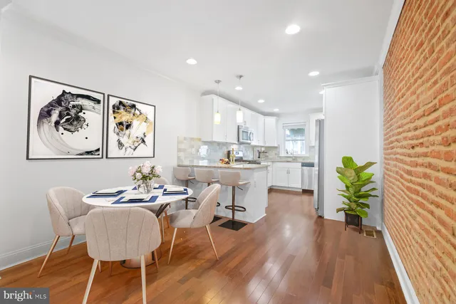 a dining room with furniture and a floor to ceiling window