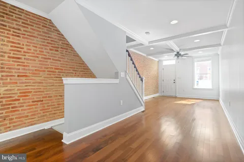 a view of empty room with wooden floor