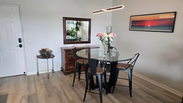 a dining room with furniture and wooden floor
