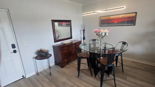 a dining room with furniture and wooden floor