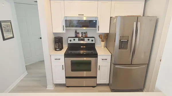 a kitchen with a refrigerator sink and stove