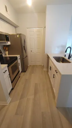 a view of a kitchen with a sink