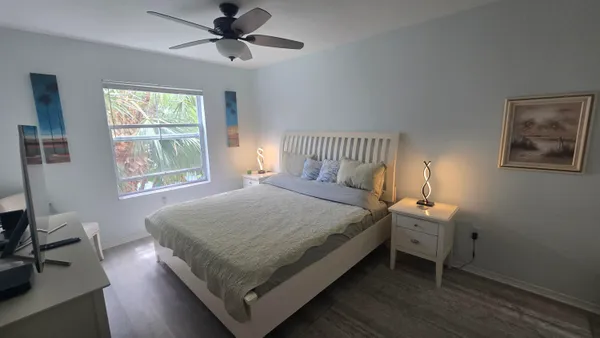 a bed sitting in a bedroom next to a window