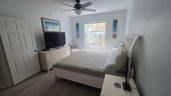 a bed room with a bed tv and a window