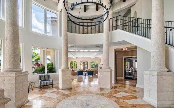 a view of a hallway with dining area and chandelier