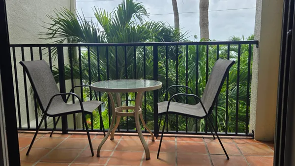 a view of a chairs and table in patio