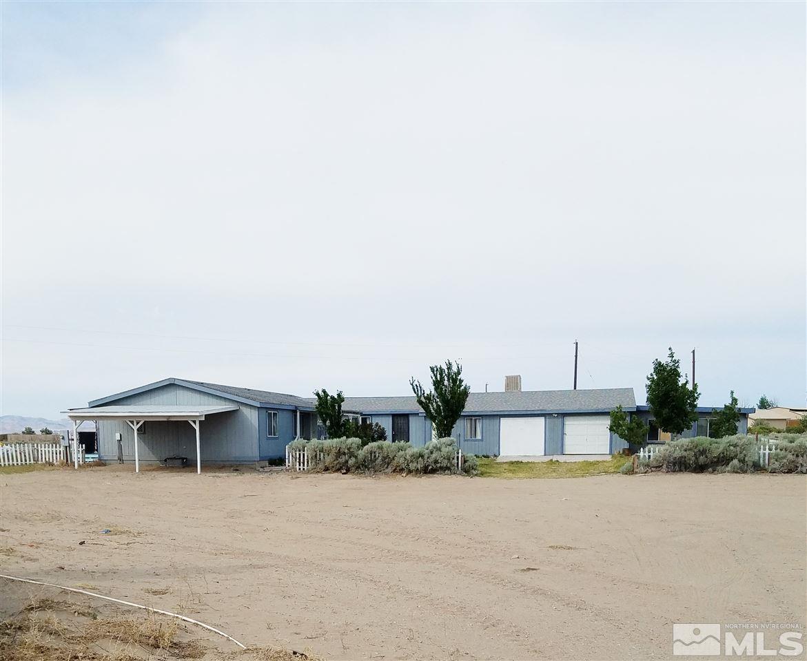 5010 Lone Tree Road Fallon, NV 89406 - Photo 1 of 1 a front view of a house with a yard and garage