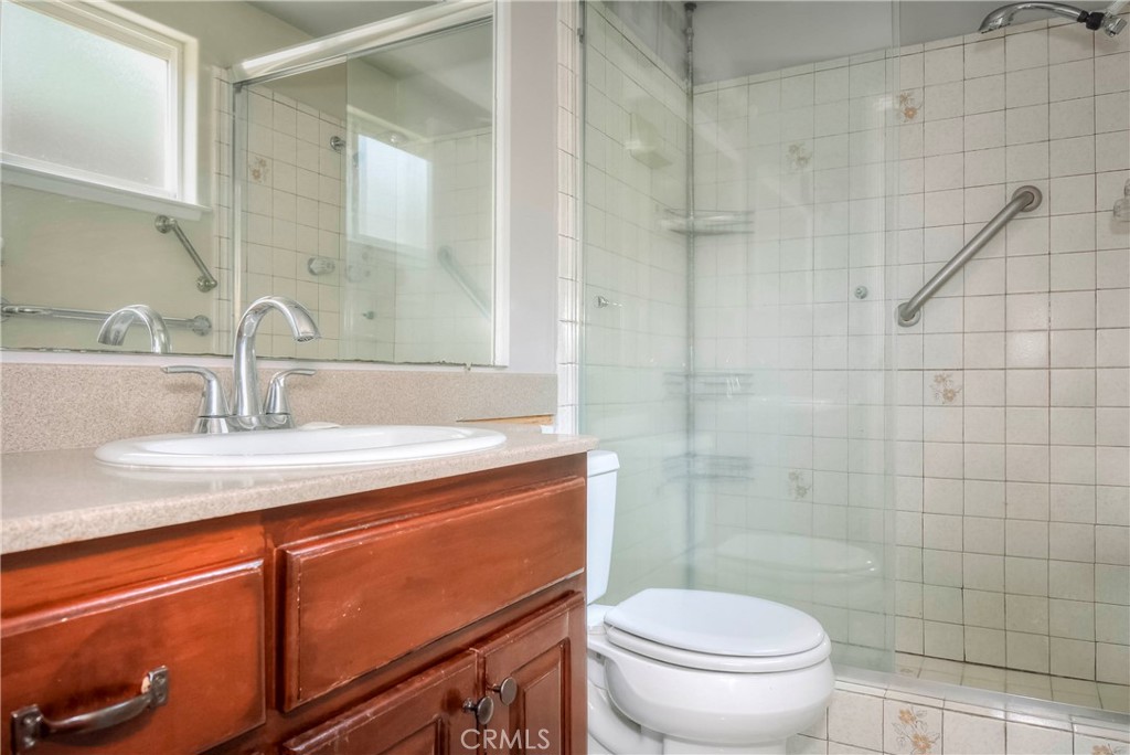 3446 Briarvale Street Corona, CA 92879 - Photo 24 of 37 a bathroom with a granite countertop sink toilet and a mirror