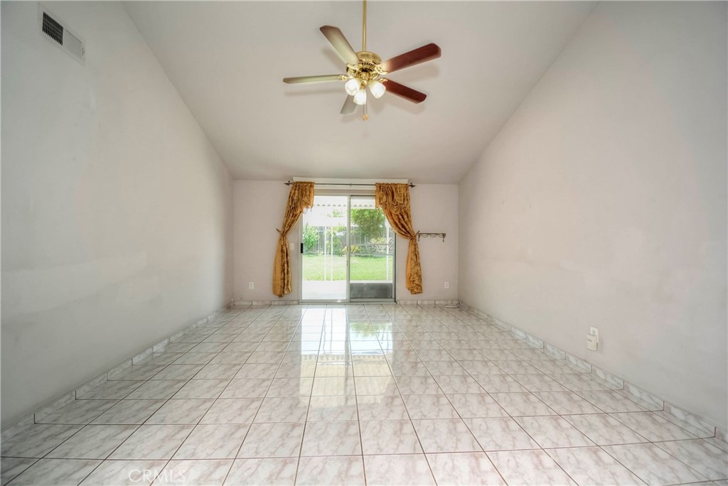 3446 Briarvale Street Corona, CA 92879 - Photo 7 of 37 an empty room with chandelier fan and windows