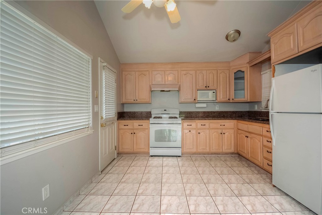 3446 Briarvale Street Corona, CA 92879 - Photo 9 of 37 a kitchen with a stove top oven sink and cabinets
