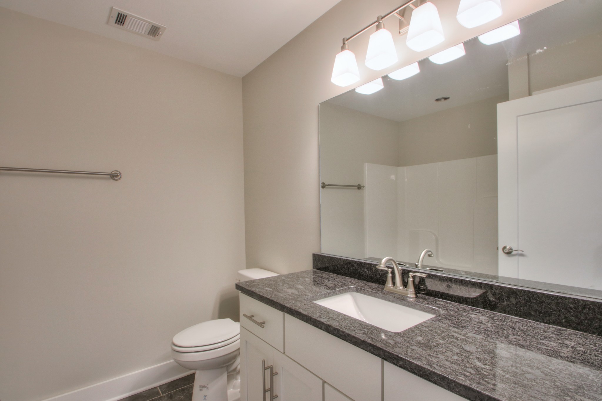 1140 Commerce Church Road Watertown, TN 37184 - Photo 20 of 21 a bathroom with a granite countertop sink a toilet and a mirror