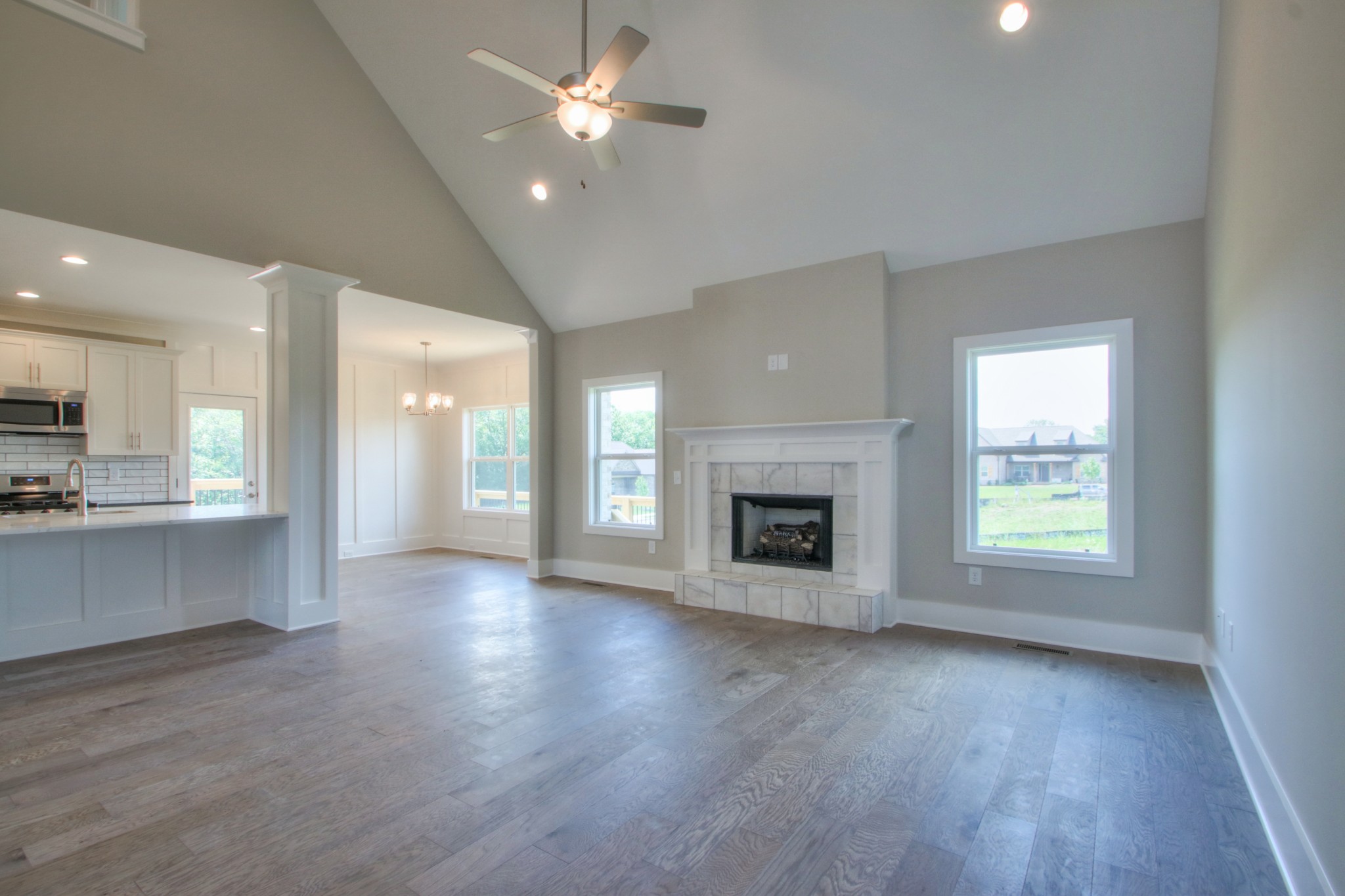 1140 Commerce Church Road Watertown, TN 37184 - Photo 6 of 21 an empty room with wooden floor fireplace cabinet and windows