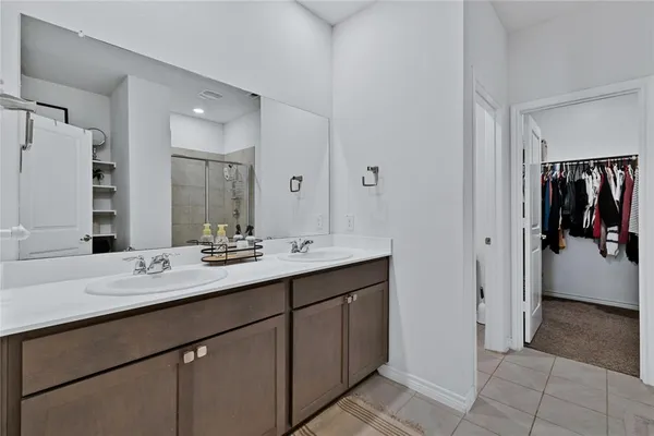 a en suite bathroom with a double vanity sink a and a mirror