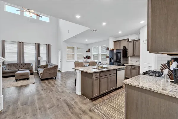 a large kitchen with stainless steel appliances lots of counter top space