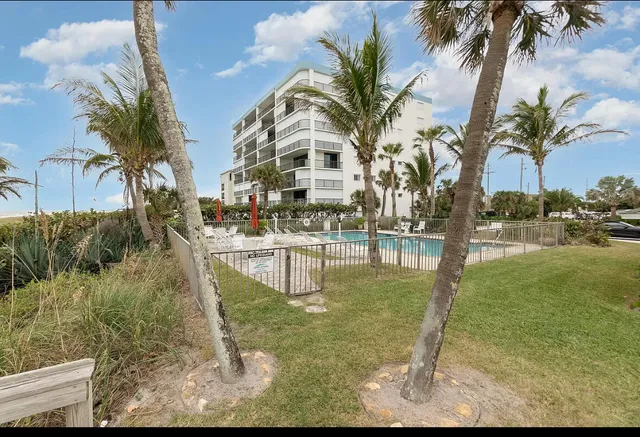 a front view of a house with a garden and yard