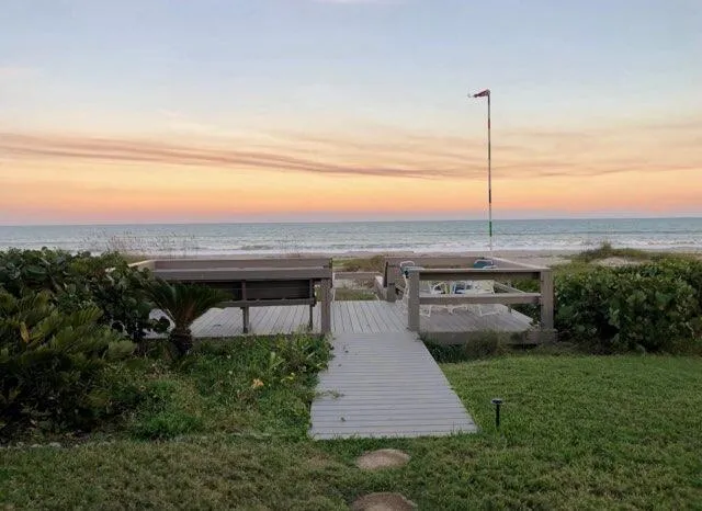 a view of a swimming pool with a garden and deck