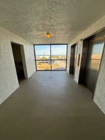 a view of an empty room with a fireplace