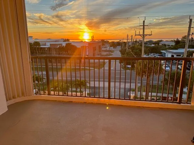 a view of a balcony with a floor to ceiling window and stairs