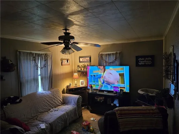 a living room with furniture and a flat screen tv