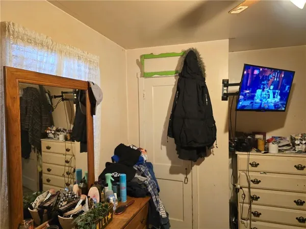 a view of a room with workspace and a chandelier fan