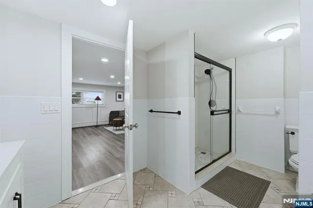 a view of a bathroom with a shower and a sink