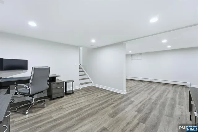 a view of a workspace with furniture and a window