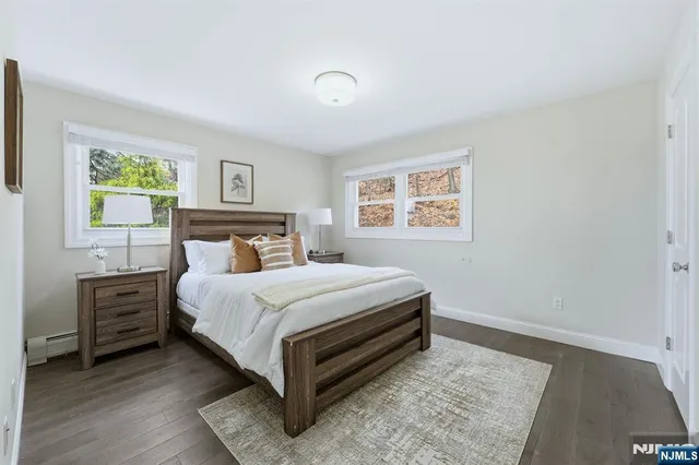 a bedroom with a bed lamp and a window