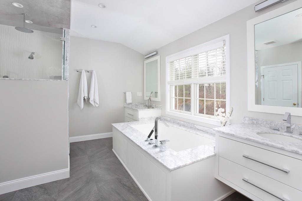 31 Greenwood Road Hopkinton, MA 01748 - Photo 18 of 27 a bathroom with a bathtub sink and mirror