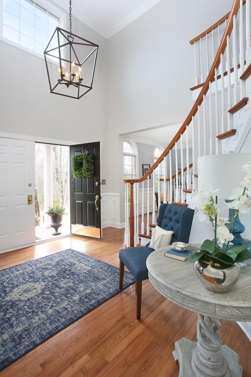 31 Greenwood Road Hopkinton, MA 01748 - Photo 2 of 27 a living room with wooden floor and a dining table