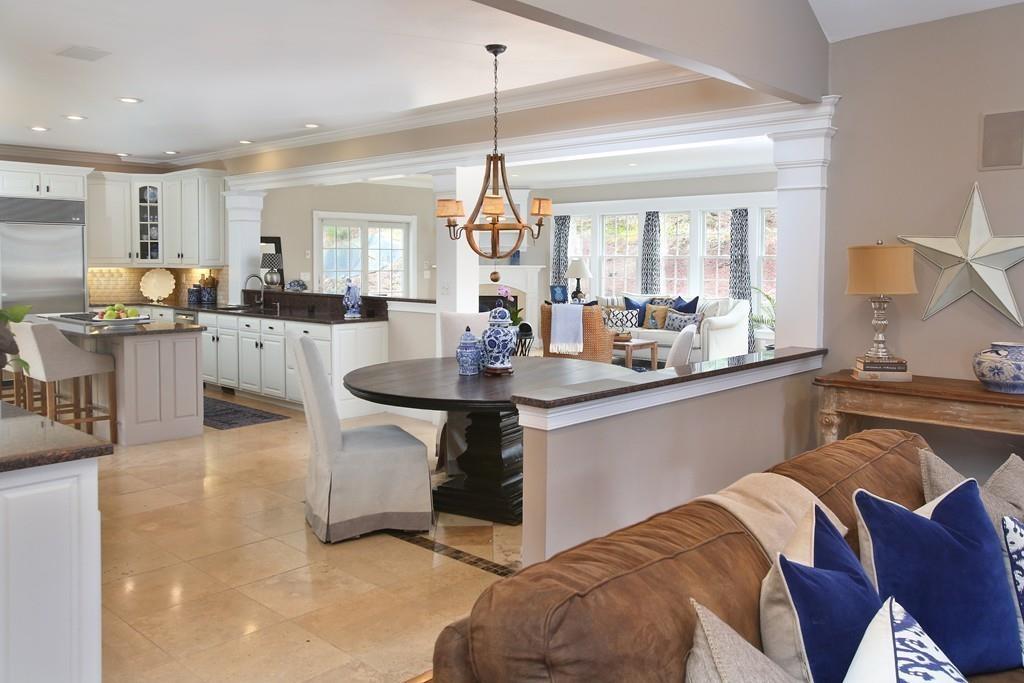 31 Greenwood Road Hopkinton, MA 01748 - Photo 5 of 27 a kitchen with stainless steel appliances granite countertop a sink dishwasher a stove a dining table and chairs with wooden floor
