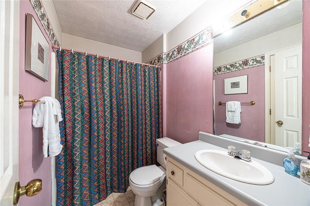 633 Iris Road Pine Lake, GA 30072 - Photo 16 of 39 a bathroom with a sink toilet and shower