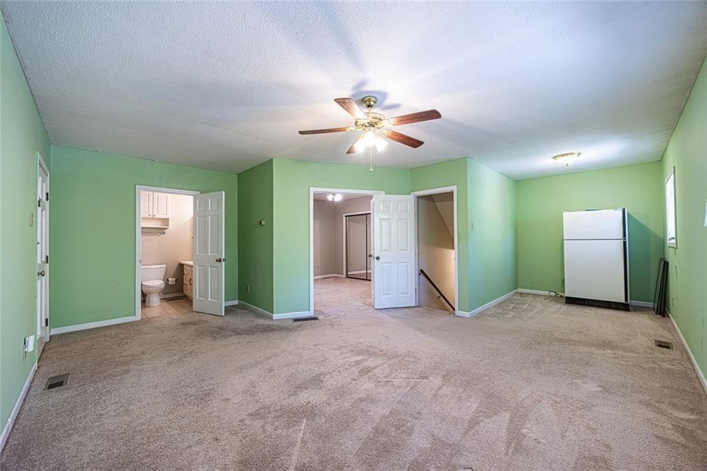 633 Iris Road Pine Lake, GA 30072 - Photo 18 of 39 a view of a big room with closet and chandelier fan