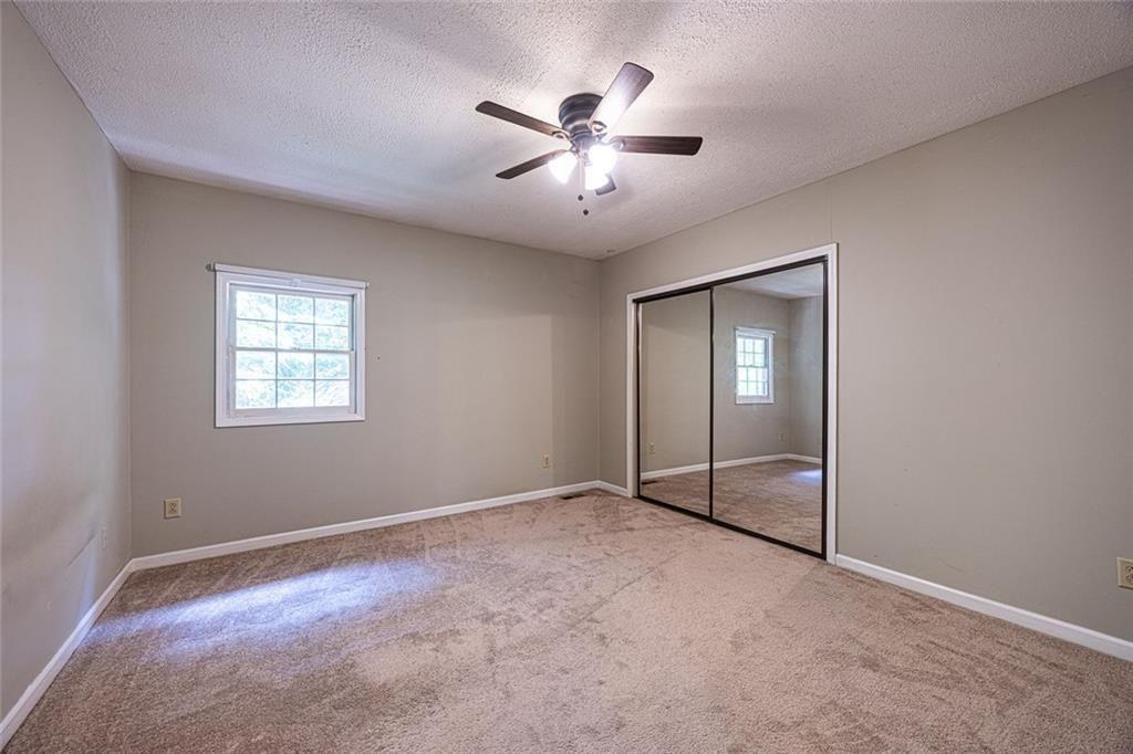 633 Iris Road Pine Lake, GA 30072 - Photo 19 of 39 an empty room with fan and windows