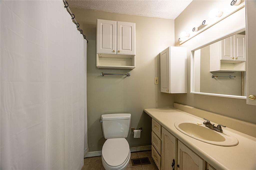633 Iris Road Pine Lake, GA 30072 - Photo 20 of 39 a bathroom with a sink a toilet and mirror