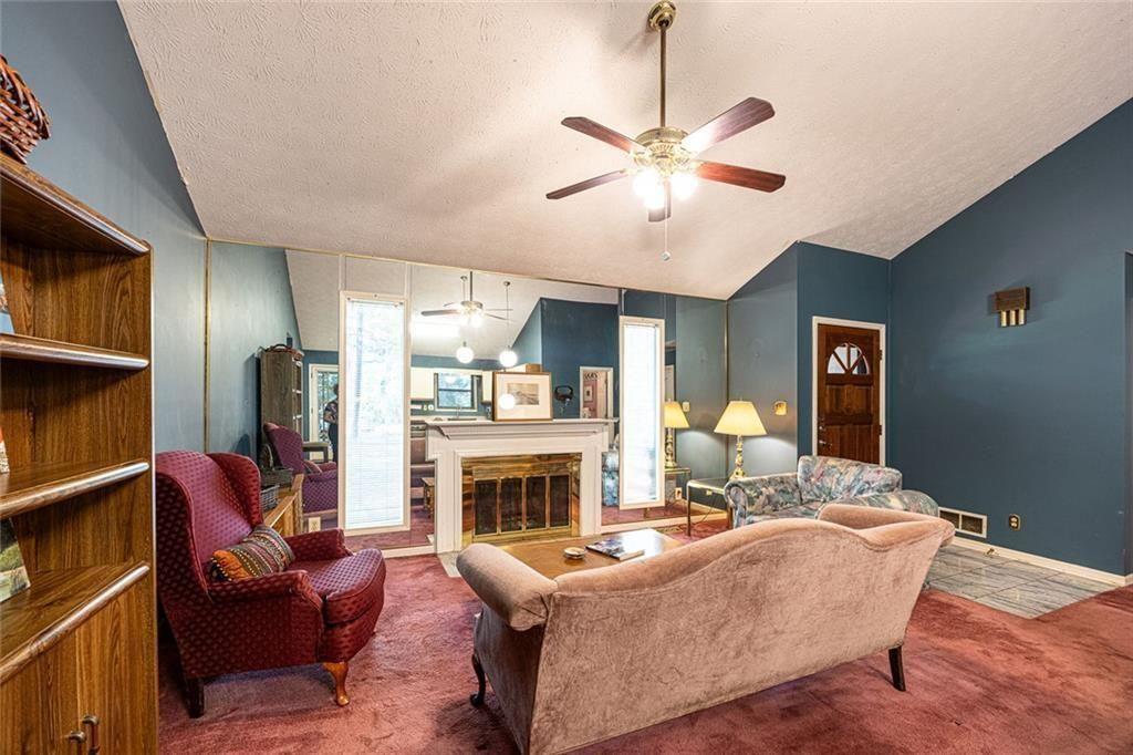 633 Iris Road Pine Lake, GA 30072 - Photo 28 of 39 a living room with furniture and a fireplace
