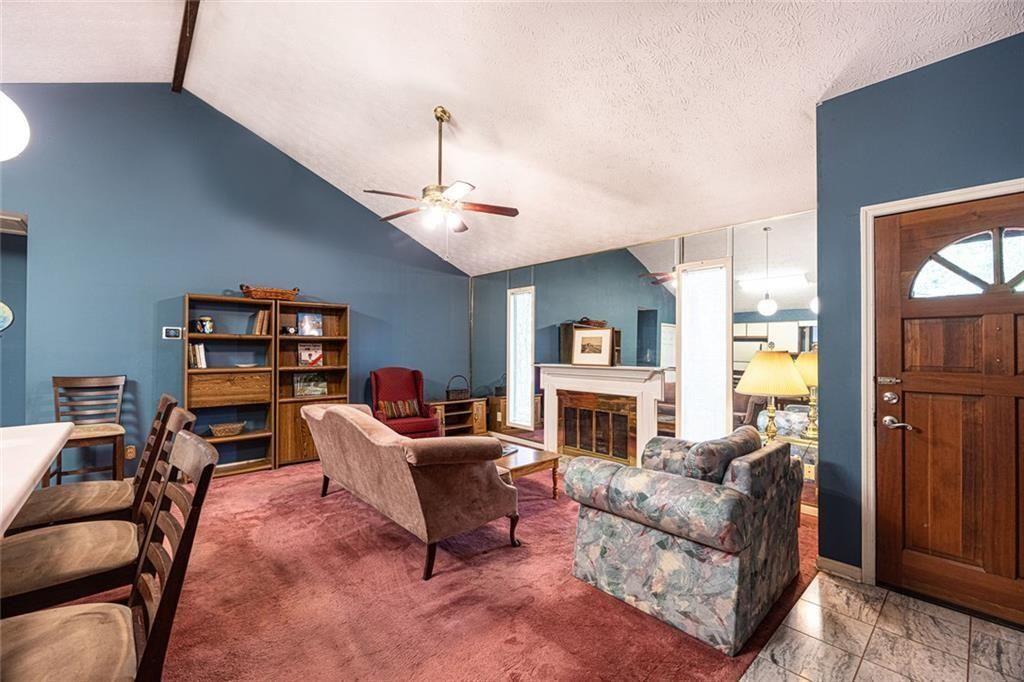 633 Iris Road Pine Lake, GA 30072 - Photo 29 of 39 a living room with furniture and a fireplace