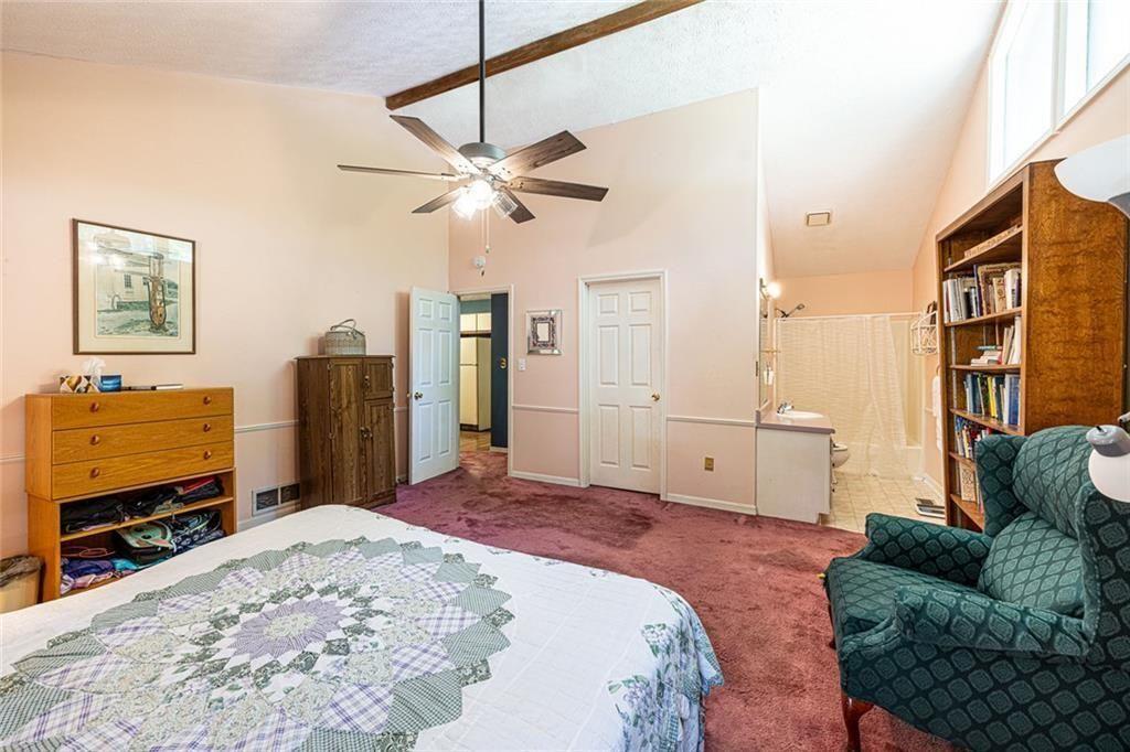 633 Iris Road Pine Lake, GA 30072 - Photo 33 of 39 a bedroom with a bed a couch and dresser