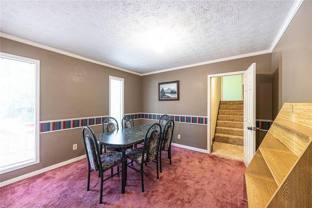 633 Iris Road Pine Lake, GA 30072 - Photo 37 of 39 a view of a dining room with furniture window and wooden floor