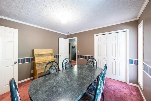a dining room with furniture and a window