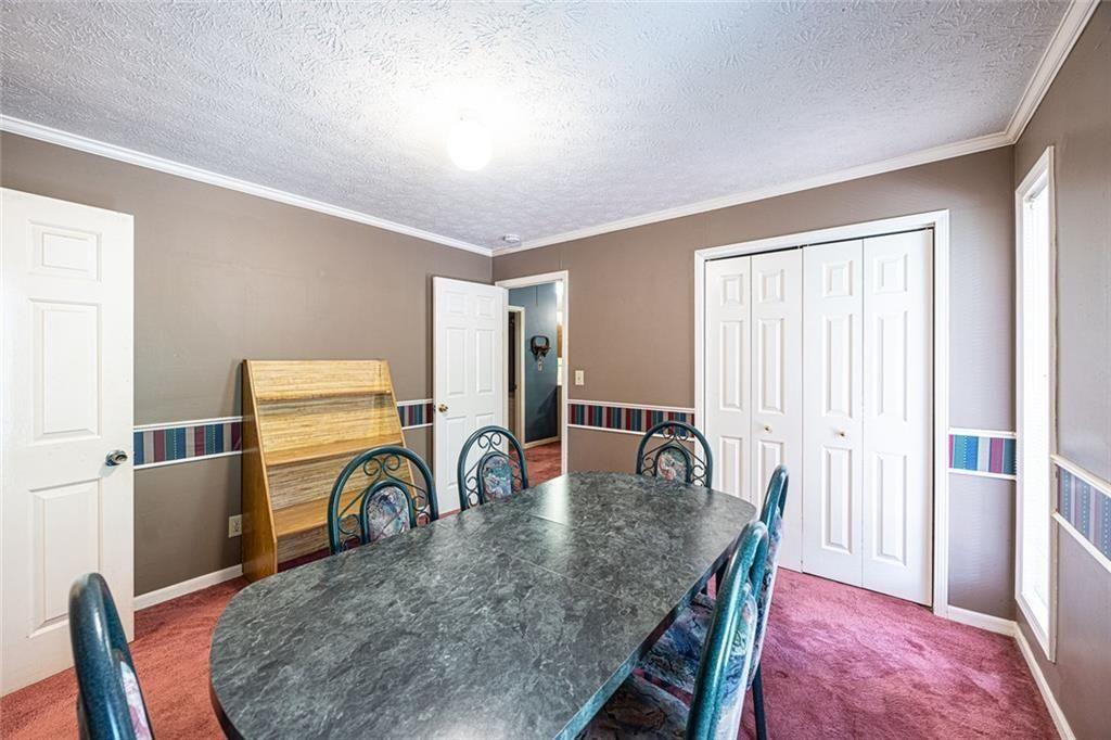 633 Iris Road Pine Lake, GA 30072 - Photo 38 of 39 a dining room with furniture and a window