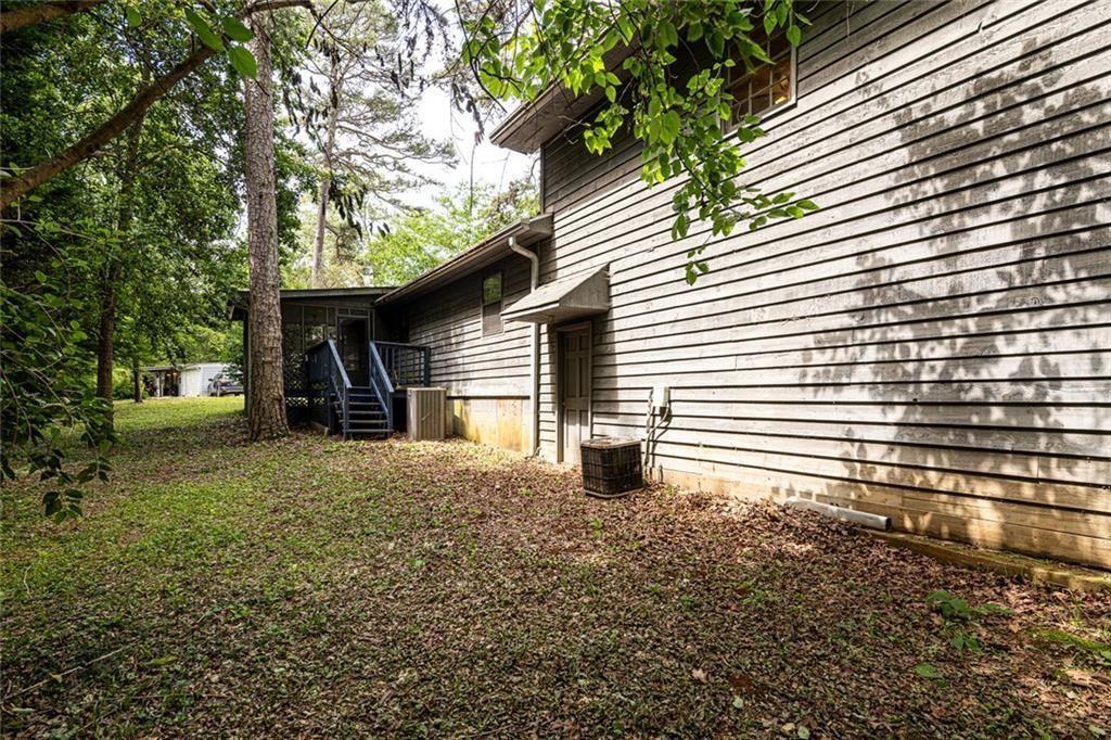 633 Iris Road Pine Lake, GA 30072 - Photo 7 of 39 a front view of a house with a yard and garage