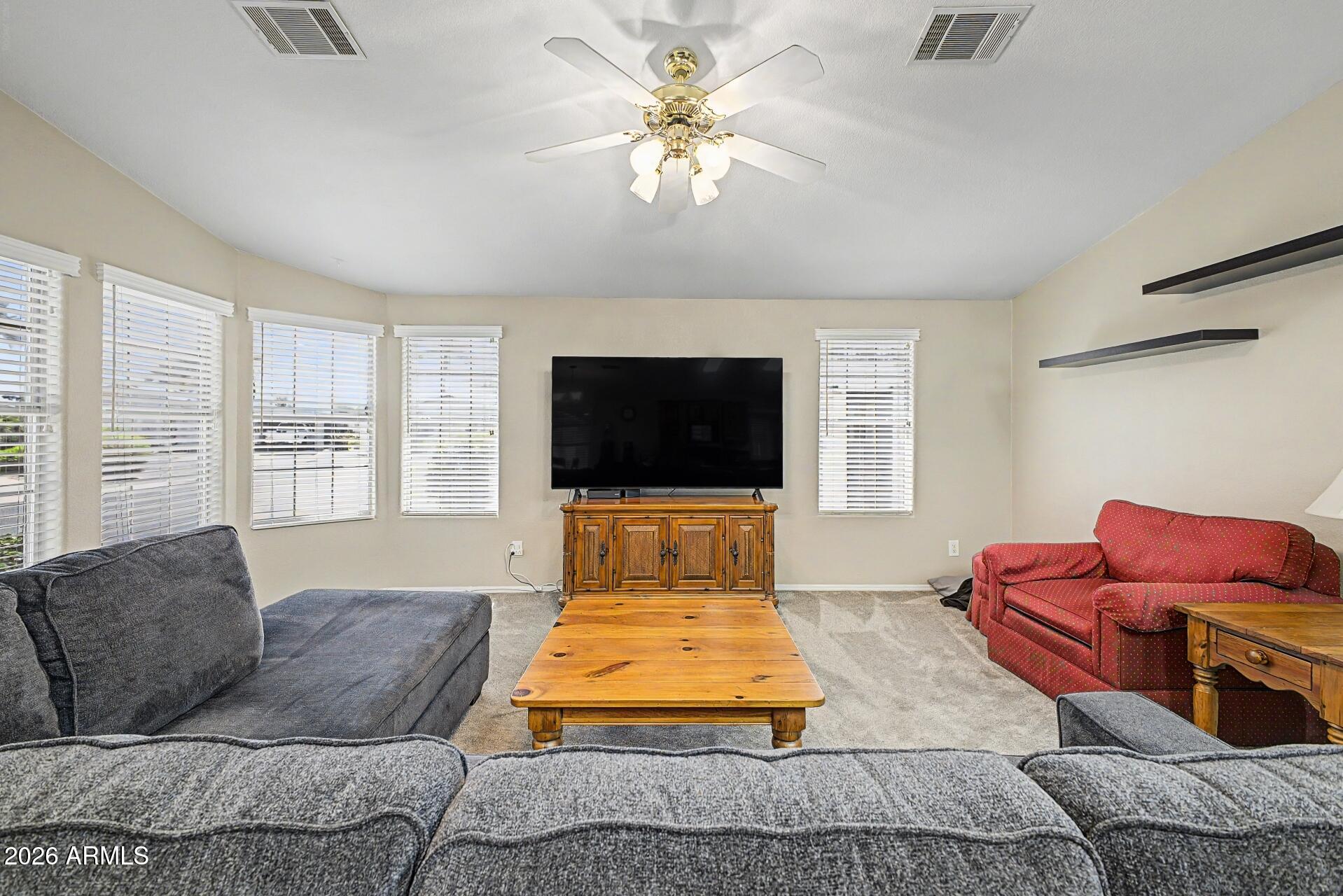 2550 South Ellsworth Road, Unit 46 Mesa, AZ 85209 - Photo 11 of 46 a living room with furniture fireplace and flat screen tv