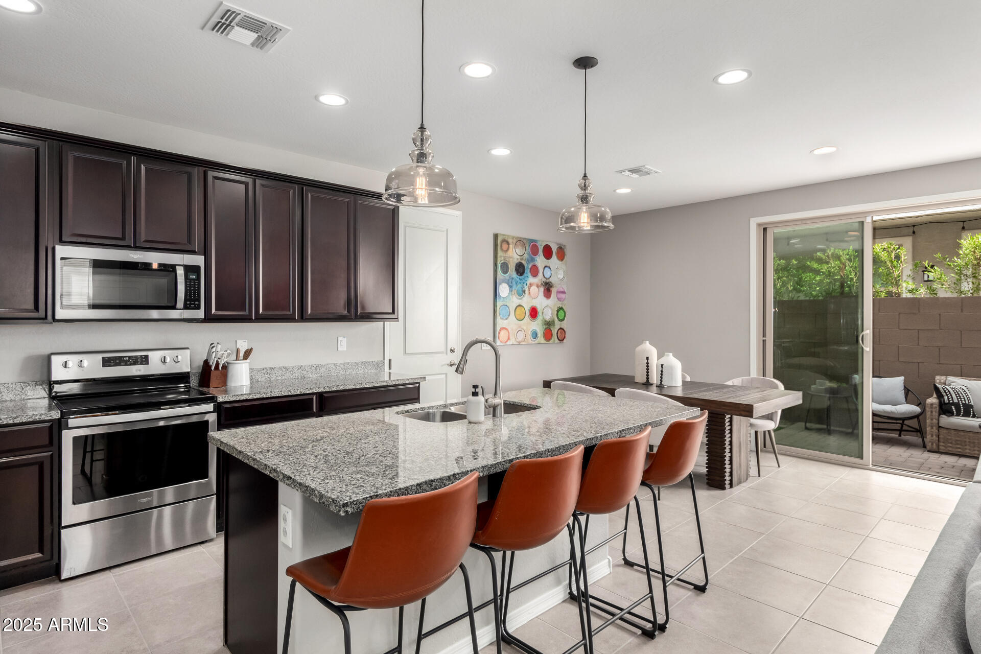 17160 North 9th Place Phoenix, AZ 85022 - Photo 13 of 46 a kitchen with stainless steel appliances granite countertop a stove a sink a microwave a dining table and chairs